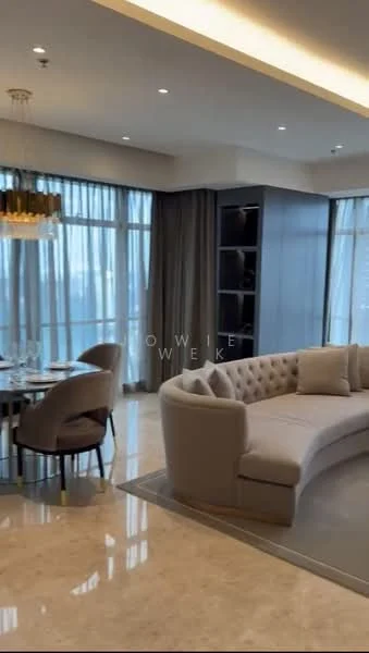 Living features: curved beige fabric sofa, marble flooring, chandelier with multiple bulbs, floor-to-ceiling windows, sheer curtains, dark wood shelving unit, area rug, decorative wall paneling, recessed ceiling lights, dining table with upholstered chairs; style: modern; view: city.