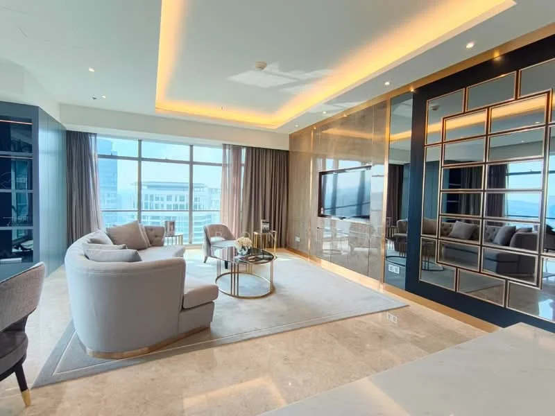 Living features: grey fabric sofa, 2 armchairs, round coffee table, TV mounted on wall, marble flooring, recessed LED downlights, crown moulding, floor-to-ceiling windows, curtains, decorative mirror, area rug, accent wall with gold trim; style: modern; view: city.