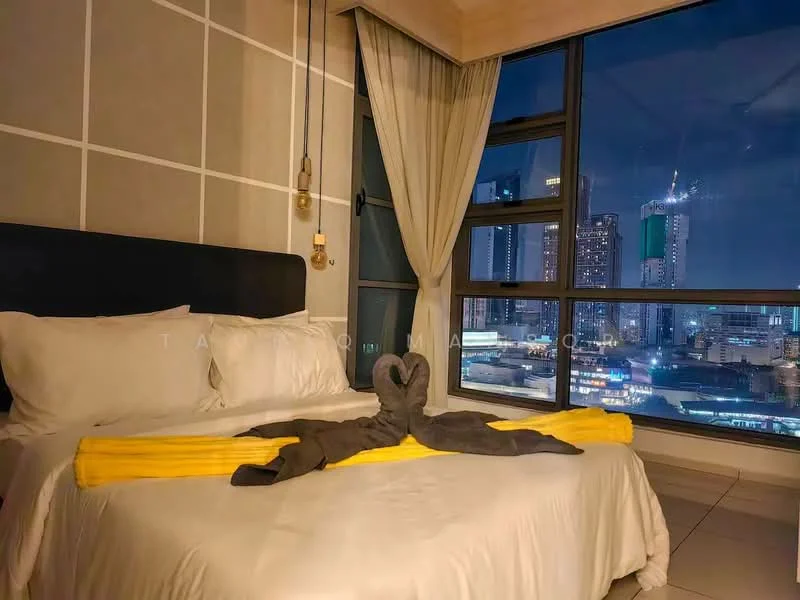 Bedroom features: king-size bed, upholstered headboard, white bedding, yellow decorative throw, floor-to-ceiling windows, city skyline view, curtains, table lamp, decorative towel swan, grey accent wall, tile flooring, recessed lighting; style: modern; view: city.