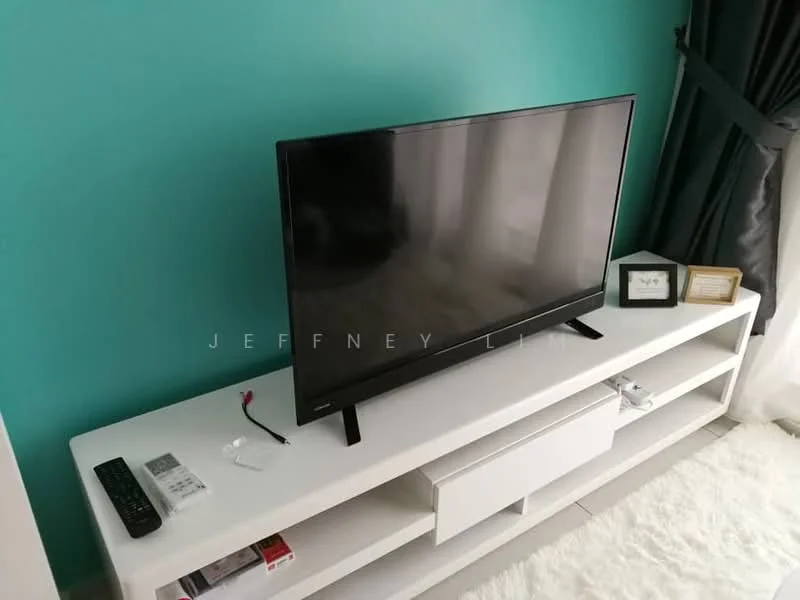 Living features: flat-screen TV on white console, white console with storage, teal accent wall, grey curtains, light-colored flooring, decorative frame on console, remote control on console, carpeted area; style: modern.