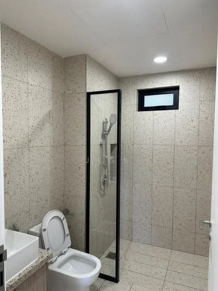Bathroom features: white toilet, glass shower enclosure, rain shower head, handheld shower, wall-mounted shower controls, light grey tile walls, light grey tile flooring, small window, vanity with sink, mirror above vanity, recessed ceiling lights; style: modern.