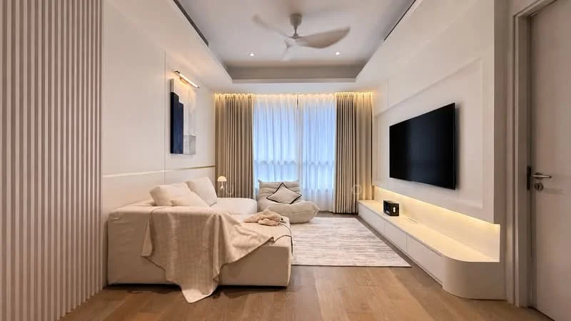 Living features: 3-seater fabric sofa in white, beige throw blanket on sofa, bean bag chair, wall-mounted TV, white media console, light wood flooring, recessed downlights, 5-blade ceiling fan, floor-to-ceiling windows with sheer curtains, decorative wall paneling, area rug with neutral tones, wall art; style: modern.