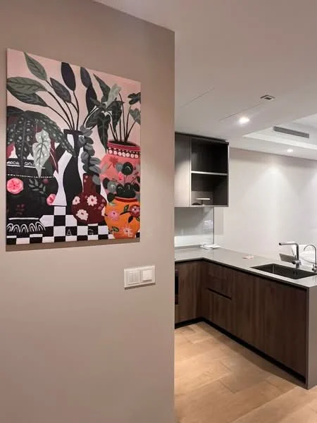 Kitchen features: dark wood cabinetry, white countertop, stainless-steel sink, chrome pull-down faucet, built-in oven, cooktop, wall-mounted cabinets, decorative wall art, recessed downlights, tile backsplash; style: modern.