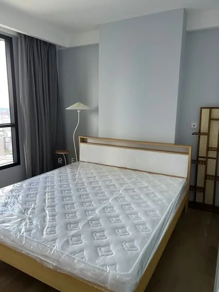 Bedroom features: queen-size bed, wooden bed frame, light grey painted walls, floor-to-ceiling windows, curtains, lampshade floor lamp, wooden bedside table, decorative room divider, wooden flooring; style: modern; view: city.