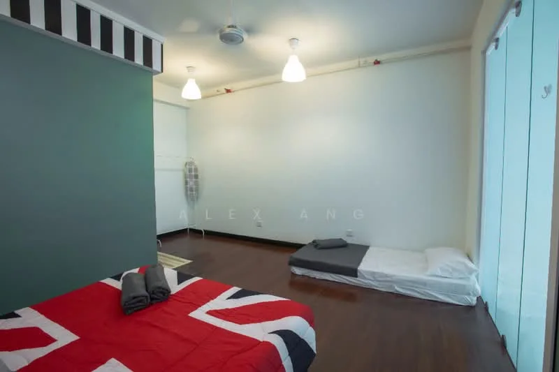 Bedroom features: wooden flooring, green accent wall, white painted walls, 2 ceiling lights, 1 ceiling fan, double bed with Union Jack bedding, single mattress on the floor, built-in wardrobe, large glass sliding door, curtains, area rug; style: modern.