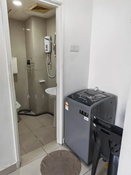 Laundry features: front-load washing machine in grey, white tiled walls, grey tiled flooring, toilet, sink, wall-mounted water heater, metal shelving unit, door leading to hallway.