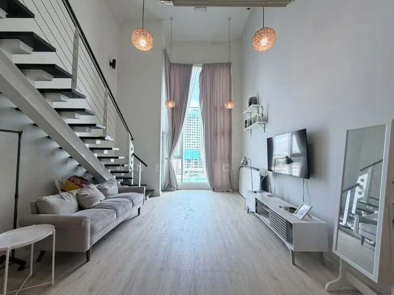 Living features: sofa in light grey fabric, coffee table, wall-mounted TV, TV console, floor-to-ceiling windows, sheer curtains, light wood flooring, high ceiling, hanging pendant lights, open staircase with metal railing, decorative wall shelf, mirror, decorative items on shelf; style: modern; view: city.