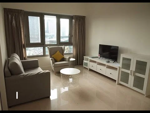 Living features: grey fabric 3-seater sofa, armchair with yellow cushion, white coffee table, white TV console with glass-fronted cabinets, wall-mounted TV, floor-to-ceiling windows, sheer curtains, polished marble flooring, decorative wall, city view; style: modern; view: city.