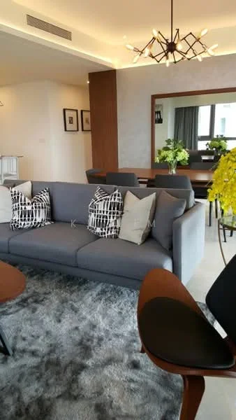 Living features: 3-seater fabric sofa in grey, decorative throw pillows with geometric pattern, area rug with soft texture, wooden coffee table, wall-mounted mirror, dining table with chairs in background, pendant light fixture, large windows with natural light, indoor plants in ceramic pots, neutral painted walls, recessed ceiling lights; style: modern.