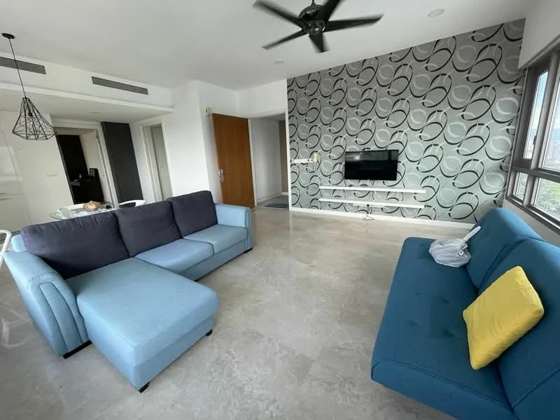 Living features: L-shape sectional sofa in blue, 2-seater fabric sofa in blue, yellow decorative cushion, wall-mounted TV, decorative feature wall with abstract pattern, marble flooring, ceiling fan, large windows with natural light, open layout, dining area visible in background; style: modern; view: city.