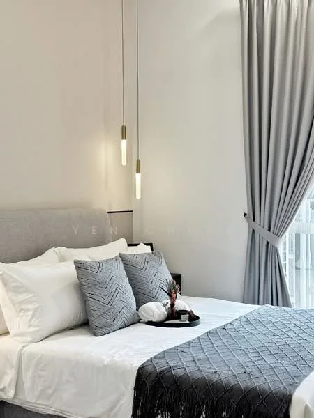 Bedroom features: king-size bed with grey upholstered headboard, white bedding with decorative pillows, grey throw blanket, two pendant lights with clear glass shades, floor-to-ceiling windows with sheer curtains, light grey curtains, decorative tray on bed, small decorative plant on tray, wall-mounted light fixture, neutral wall color; style: modern.