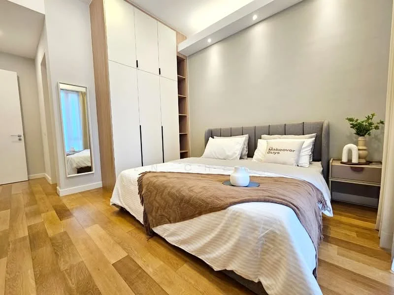 Bedroom features: queen-size bed with grey upholstered headboard, white bedding with brown throw blanket, nightstand with lamp, built-in wardrobe with sliding doors, wooden flooring, decorative plant on nightstand, framed mirror, wall-mounted light fixtures, neutral painted walls, shelves in wardrobe; style: modern.