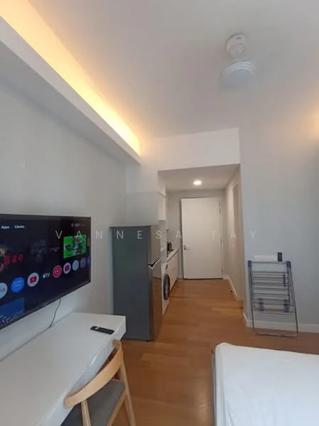 Room features: light wood flooring, white painted walls, recessed ceiling lights, wall-mounted TV, desk with chair, stainless-steel fridge, built-in washing machine, open shelving, doorway leading to hallway; style: modern.