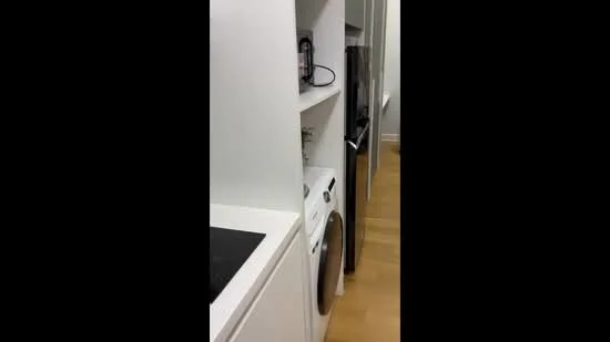 Laundry features: white cabinetry, built-in washing machine, black countertop, wooden flooring, refrigerator, shelf storage, appliance garage, modern design; style: modern.