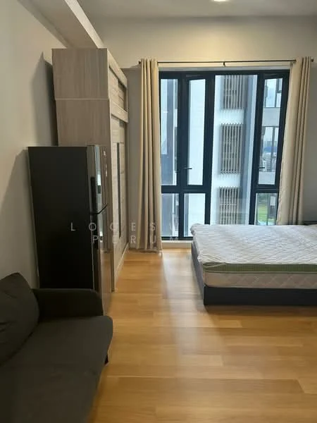 Bedroom features: queen-size bed, light wood flooring, floor-to-ceiling windows, grey curtains, black refrigerator, sofa in dark grey, wooden wardrobe, mattress on bed frame; style: modern.