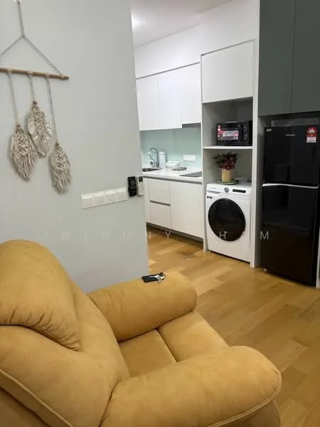 Living features: yellow fabric sofa, wooden flooring, white painted walls, kitchen cabinetry with white finish, black refrigerator, white washing machine, built-in kitchen countertop, wall-mounted intercom, decorative wall hanging; style: modern.
