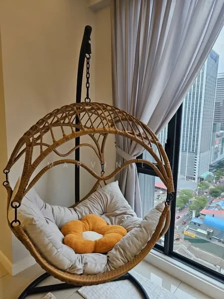 Room features: hanging rattan chair, cushioned seat, orange flower-shaped pillow, floor-to-ceiling windows, sheer curtains, city view, light-colored flooring, neutral wall color; style: modern; view: city.