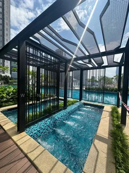 Exterior type: swimming pool deck; features: infinity pool, water feature with jets, surrounding greenery, decking area with wooden planks, pergola structure, blue mosaic tile, landscaped garden, sun loungers area; style: modern.