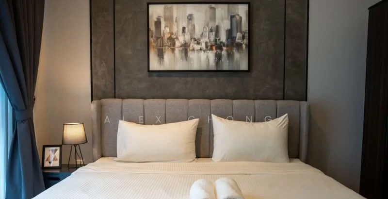 Bedroom features: king-size bed, upholstered headboard in grey, two white pillows, white bed linens, decorative artwork above the bed, grey accent wall, table lamp with warm light, curtains in dark blue, wooden wardrobe, framed artwork, decorative items on bedside table; style: modern; view: city.