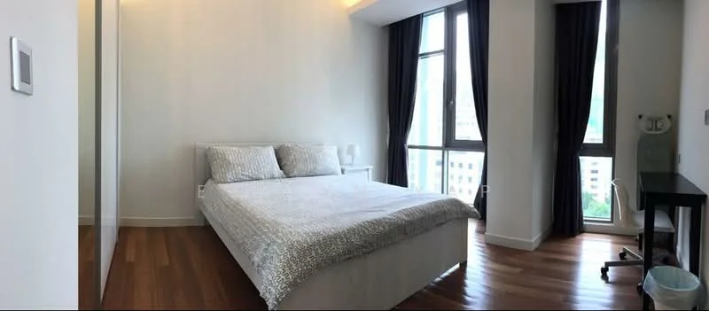 Bedroom features: queen-size bed with patterned bedding, floor-to-ceiling windows, dark curtains, wooden flooring, white painted walls, nightstand, table lamp, study desk, chair, built-in wardrobe; style: modern; view: city.
