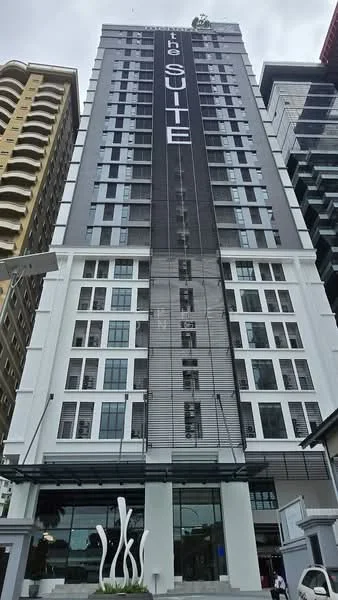 Exterior type: high-rise condominium; features: glass curtain wall, white painted facade, black accent panels, recessed balconies, feature signage, multiple storeys, modern architectural design; style: modern.