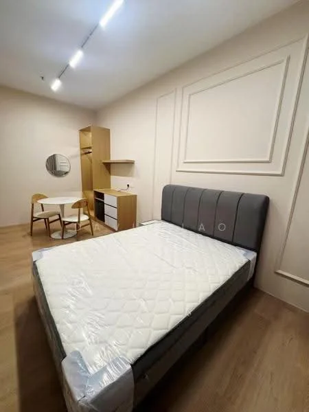 Bedroom features: queen-size bed with grey upholstered headboard, mattress with protective cover, light wood flooring, white painted walls, built-in wardrobe with sliding doors, study desk with chair, round mirror, shelf unit, recessed ceiling lights; style: modern.