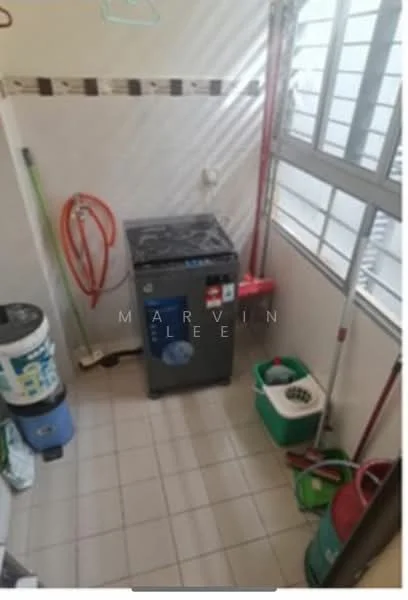 Laundry features: front-load washing machine, white tiled flooring, grey walls, window with horizontal slats, red hose, blue bucket, green cleaning bucket, mop, broom, cleaning supplies, shelf with hangers.