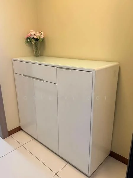 Room features: white cabinetry, glossy finish, single drawer, double-door cabinet, decorative vase with flowers, neutral wall colour, tile flooring; style: modern.