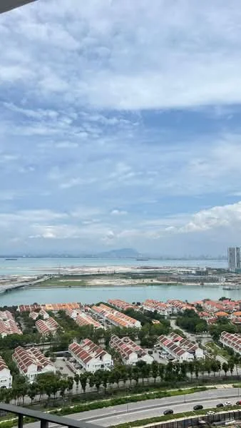 Exterior type: high-rise condominium; features: city skyline view, sea view, surrounded by residential houses, manicured landscaping, paved road, greenery along the road; style: modern.