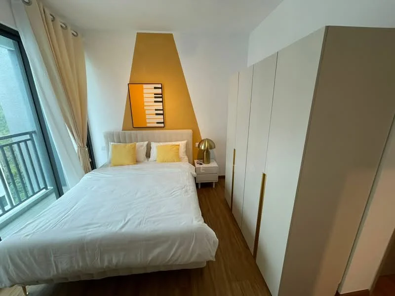 Bedroom features: queen-size bed with white bedding, yellow accent pillows, light wood flooring, white painted walls, gold accent wall with piano design, floor-to-ceiling windows, sheer curtains, built-in wardrobe with sliding doors, nightstand with lamp; style: modern.