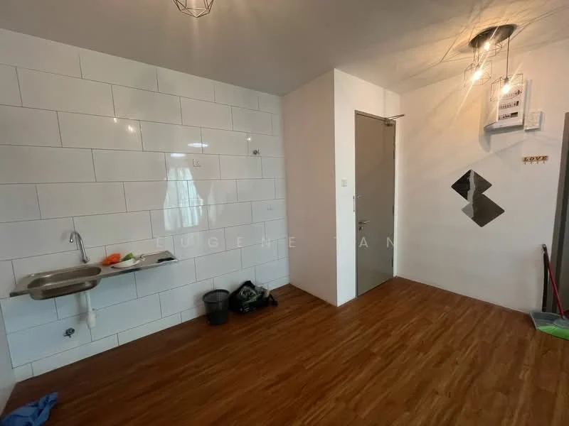 Room features: white tiled walls, wood laminate flooring, single-bowl stainless-steel sink, chrome faucet, wall-mounted light fixture, door with silver handle, electrical panel on wall, trash bin, cleaning supplies on floor; style: modern.