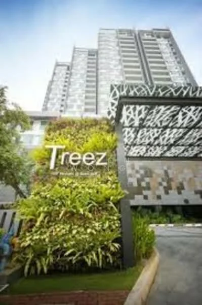 Exterior type: high-rise condominium; features: green wall with plants, modern entrance gate, stone cladding on facade, glass curtain wall, surrounded by landscaping, driveway leading to entrance, multi-storey building, decorative feature lighting; style: modern.