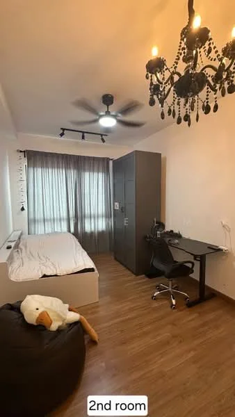 Bedroom features: queen-size bed with white bedding, wooden flooring, chandelier light fixture, 5-blade ceiling fan, floor-to-ceiling windows with sheer curtains, built-in wardrobe in dark grey, study desk with black chair, bean bag chair, decorative wall art, power outlet on wall; style: modern; view: city.