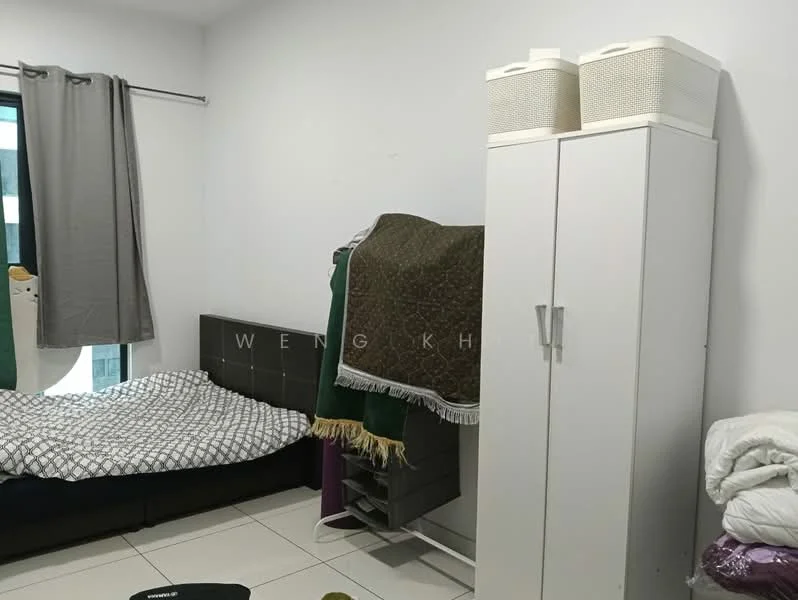 Bedroom features: queen-size bed with patterned bedding, white painted walls, tile flooring, floor-to-ceiling window with grey curtains, white wardrobe cabinet, open shelving unit, blankets draped over furniture, decorative storage baskets.