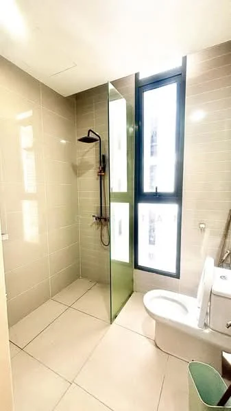 Bathroom features: walk-in shower with glass enclosure, rain shower head, chrome basin mixer, one-piece toilet, grey tiled walls, light-coloured floor tiles, large window for natural light, green glass partition; style: modern.