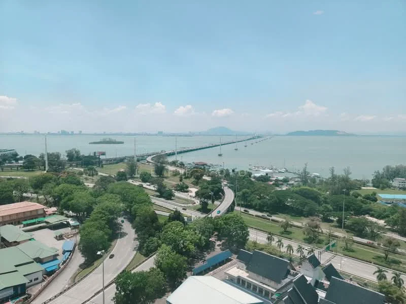 Exterior features: view of the sea, view of the bridge, lush greenery, urban landscape, roadways visible, waterfront area.