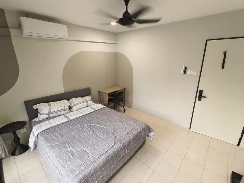 Bedroom features: queen-size bed with grey bedding, 2 bedside tables, black ceiling fan, wall-mounted air conditioning unit, light grey painted walls, cream tiled flooring, wooden study desk, black chair, white door, wall-mounted intercom, decorative wall design; style: modern.
