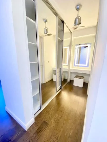 Room features: wooden flooring, built-in mirrored wardrobe, open shelving, ceiling fan, recessed lighting, vanity area with mirror, white painted walls, neutral decor; style: modern.