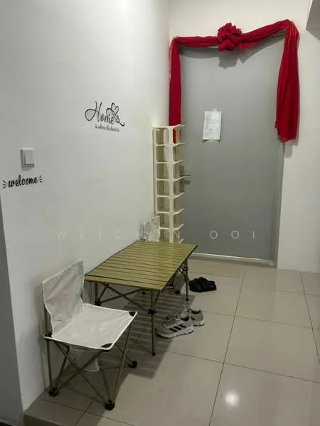 Room features: white painted walls, glossy tile flooring, small folding table, white folding chair, shoe rack, decorative wall art, red fabric drapery, door with frosted glass panel; style: modern.