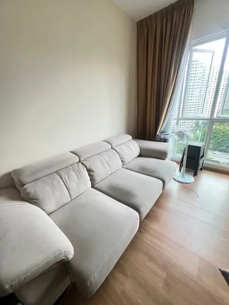 Living features: L-shape sectional sofa in light grey fabric, wooden flooring, floor-to-ceiling windows, sheer curtains, side table, decorative plant, neutral painted walls; style: modern; view: city.