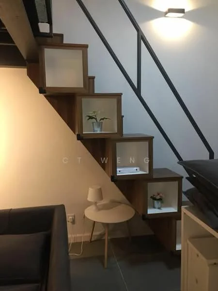 Room features: wooden staircase with open shelving, white walls, recessed lighting, grey flooring, small round side table, table lamp, decorative plants on shelves, metal railing; style: modern.