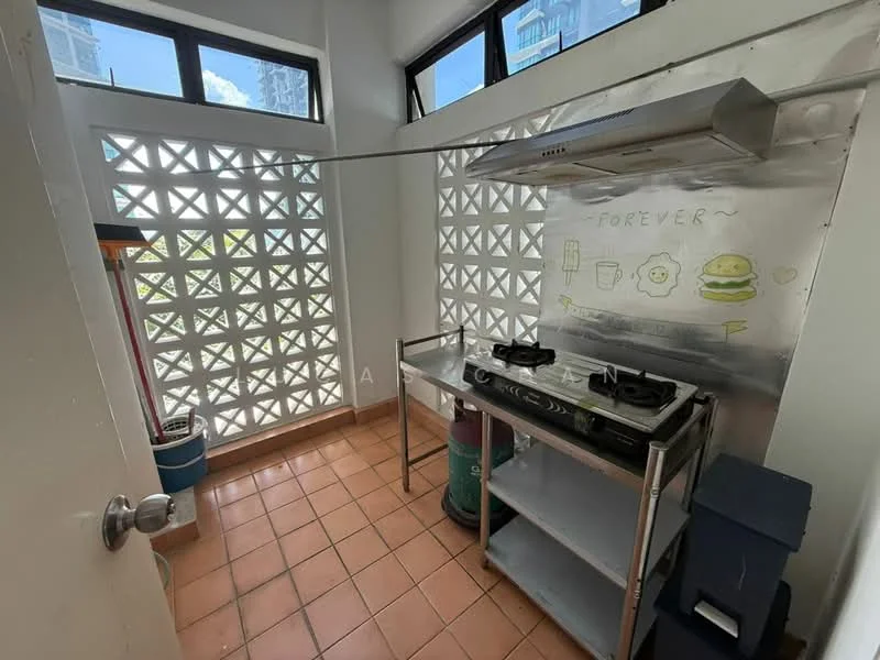Kitchen features: stainless-steel gas stove with two burners, stainless-steel range hood, metal shelving unit, orange terracotta tile flooring, decorative block wall, window with natural light, wall-mounted artwork, green gas cylinder, blue storage container; style: modern.