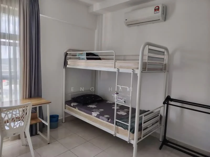 Bedroom features: bunk bed with metal frame, mattress on top and bottom bunk, white walls, tile flooring, window with sheer curtains, wall-mounted split AC, study table with chair, clothes rack, blue waste bin.