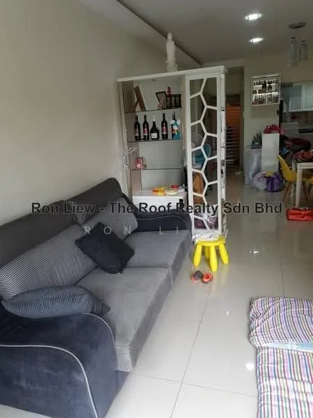 Living features: 3-seater fabric sofa in grey, white wall, glossy tile flooring, decorative room divider with geometric pattern, small yellow stool, bottles on display in room divider, toys on the floor, open layout to adjacent area; style: modern.