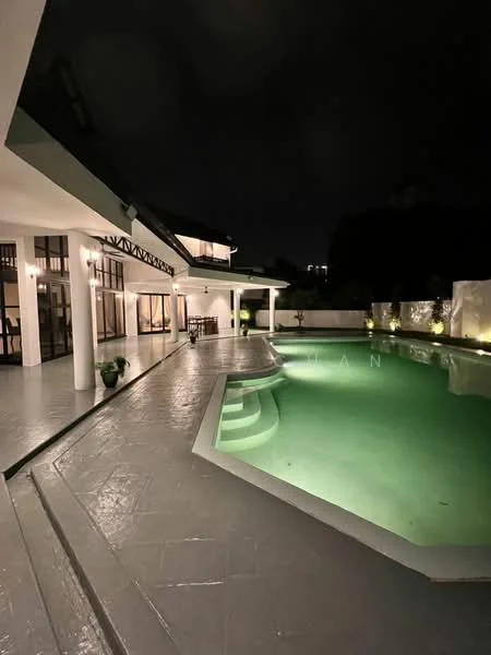 Exterior type: detached bungalow; features: swimming pool with curved edge, pool deck with loungers, outdoor lighting, manicured landscaping, covered patio area, large glass windows, white painted facade, sloped roof, multiple columns supporting the structure; style: modern.