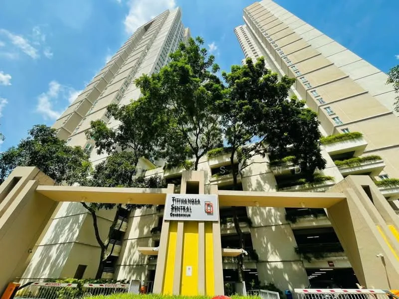 Exterior type: high-rise condominium; features: two tall residential towers, yellow and white painted facade, landscaped entrance with trees, parking deck visible, modern architectural design, clear blue sky, surrounded by greenery; style: modern.
