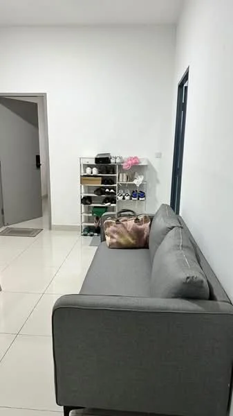 Living features: grey fabric sofa, white painted walls, glossy tile flooring, shoe rack with various shoes, decorative cushion with abstract pattern, doorway leading to another room, neutral color palette; style: modern.