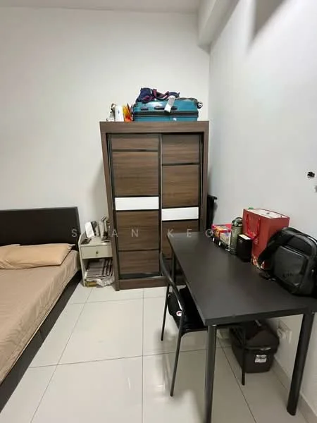Bedroom features: queen-size bed with beige bedding, wooden wardrobe with sliding doors, black study desk, black chair, white tiled flooring, white painted walls, small bedside table, luggage on top of wardrobe; style: modern.