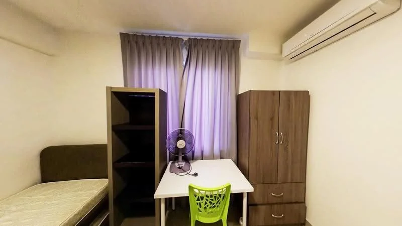 Bedroom features: single bed, green plastic chair, white desk, wooden wardrobe, wooden shelving unit, ceiling-mounted air conditioning unit, grey curtains, light grey walls, tile flooring, table fan; style: modern.