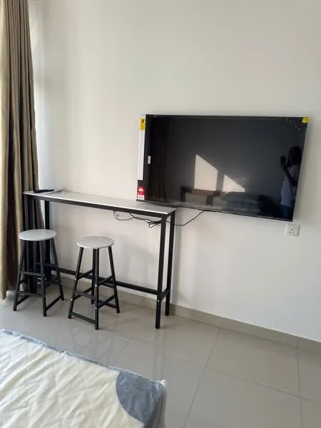 Room features: flat-screen TV mounted on wall, black metal TV console, two round stools, light-colored bedding on bed, white walls, floor-to-ceiling window with curtains, glossy tile flooring, natural light from window; style: modern.